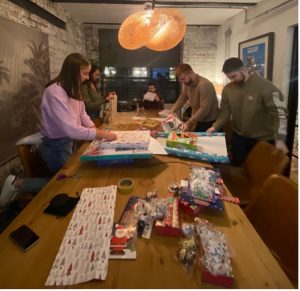 Members of Cloud Perspective wrapping Christmas presents